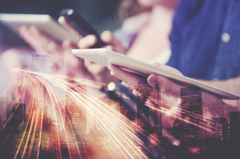 digital tablet in hand with city skyline