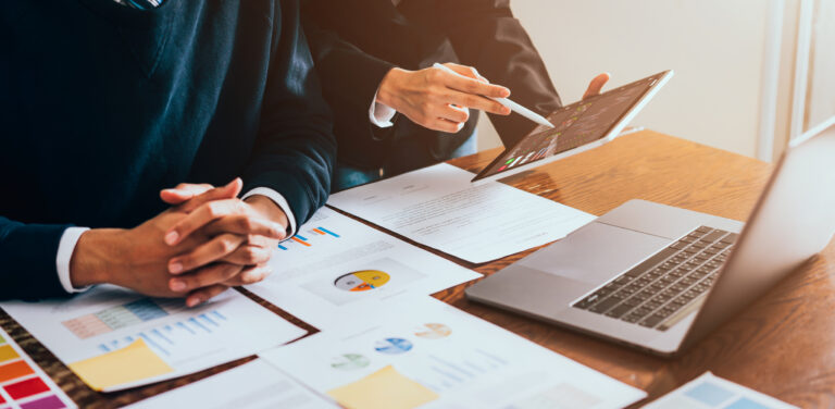 Stock exchange market concept, business team trader looking on tablet and laptop with graphs analysis candle line in office room, diagrams on screen
