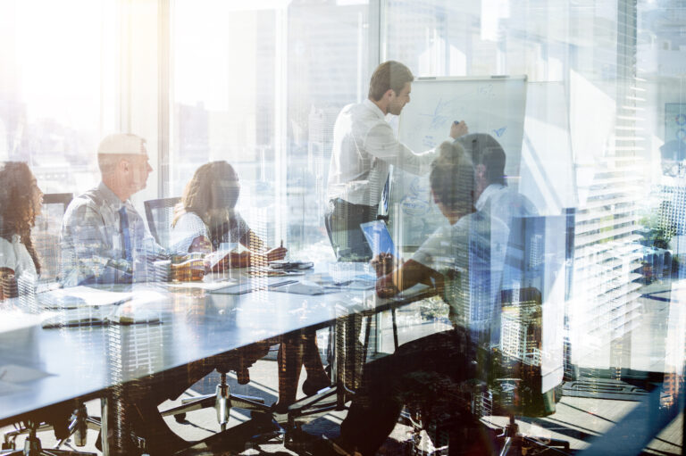 Montage of a team of business people at a presentation at the boardroom table