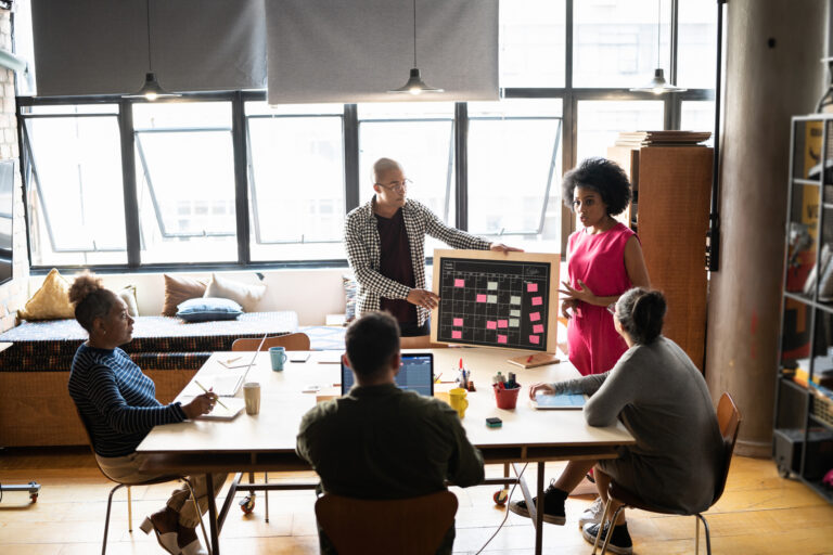 Young man and woman talking in a meeting at a coworking