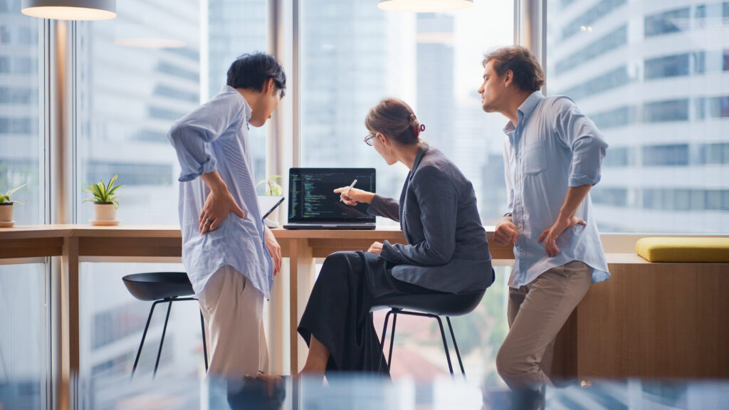 Startup team having a brainstorming session on coding strategies